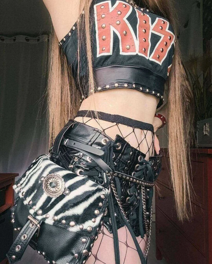 Axline Rose wearing a kiss crop top shirt with a faux leather mini skirt to a kiss concert