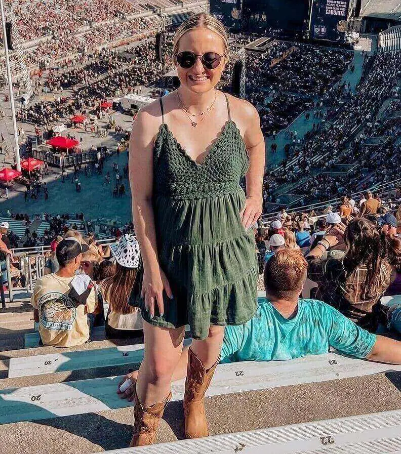 Girl wearing a shirred cami dress to a luke combs concert