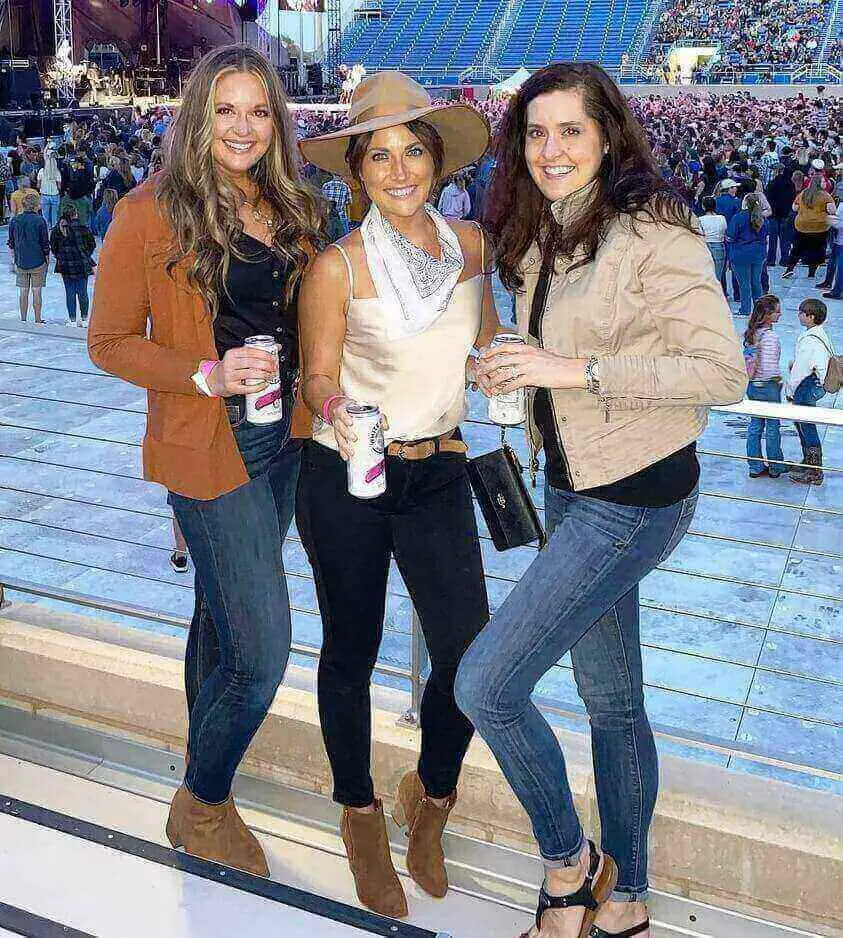 Girl wearing a bomber jacket at a winter zac brown band concert