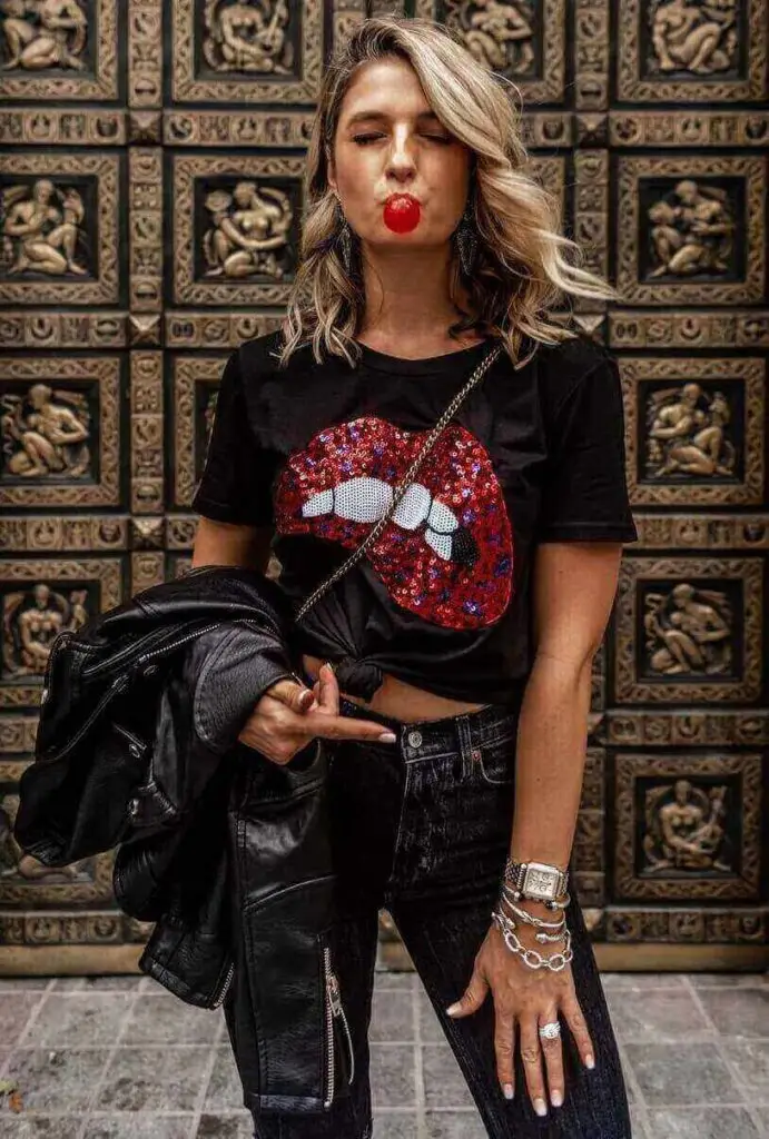 Girl wearing a sequin print shirt with black jeans for a blink 182 concert