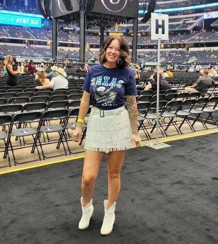 Girl wearing a sparkling skirt with a graphic t shirt at a garth brooks concert
