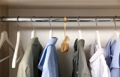 Scented sachet hanging in a closet full of clothes