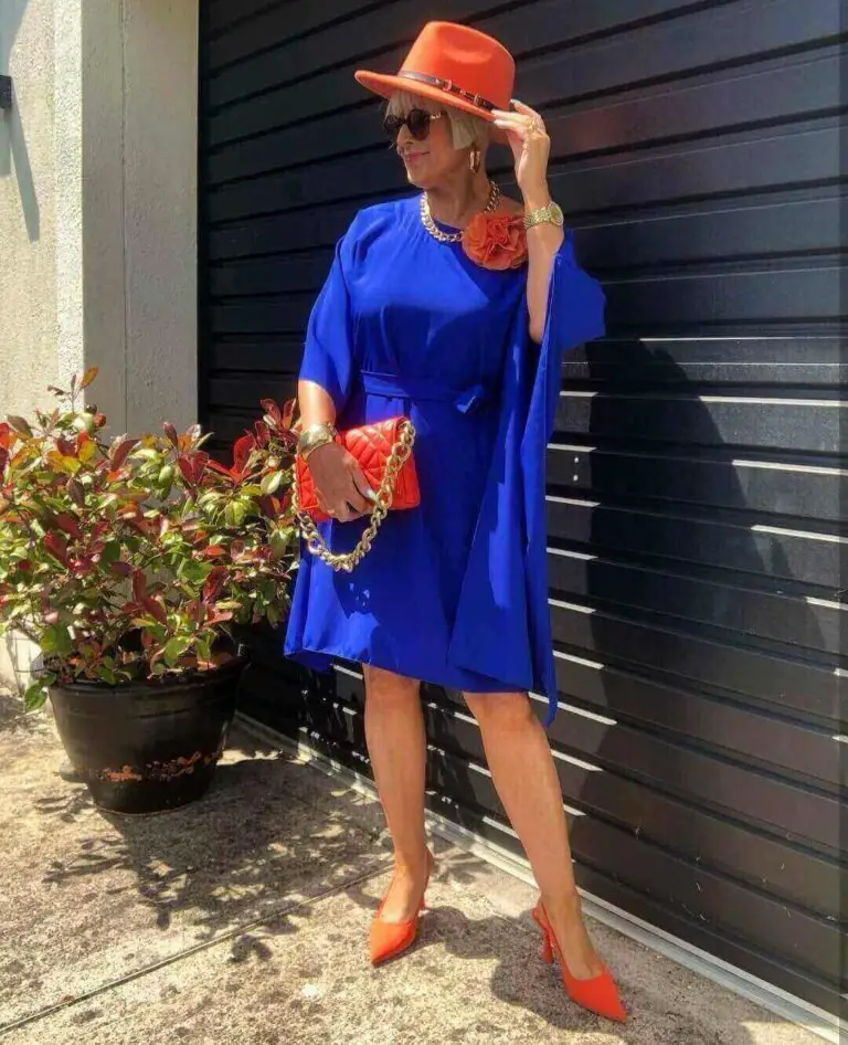 Women wearing orange heels with navy blue dress
